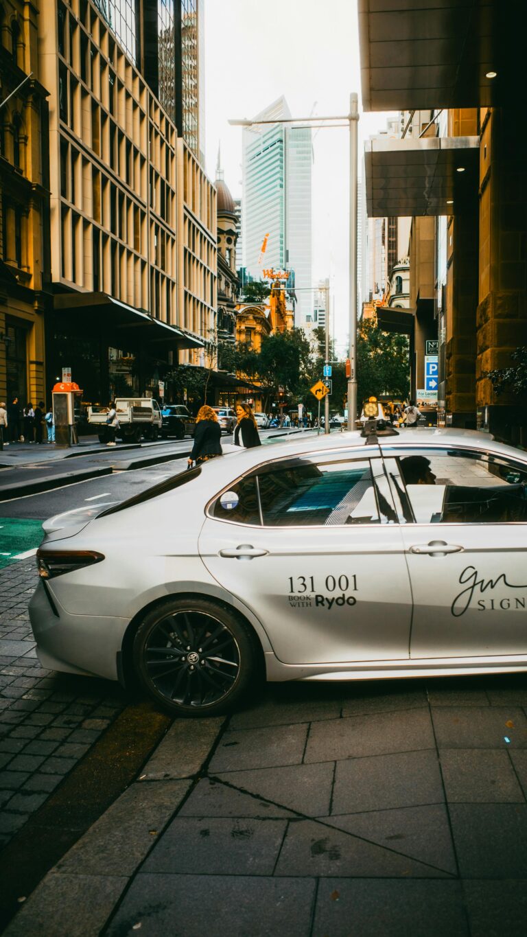 Dynamic street view in Sydney's urban area featuring a parked car and bustling cityscape.
